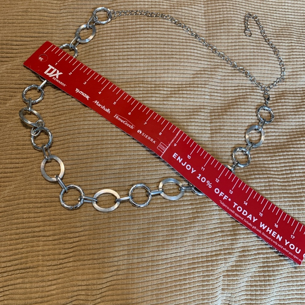 Silver tone belly belt.